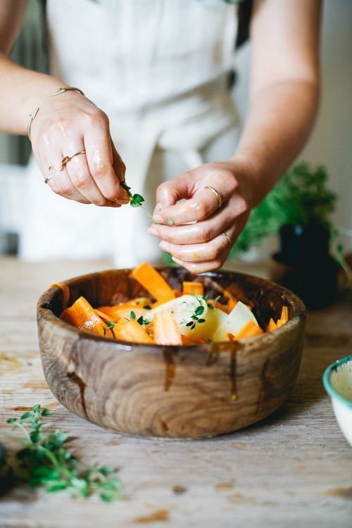 A chef finishing a plant-based dish by hand